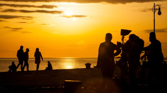 This image shows a camera crew making a video about tropical modern architecture
